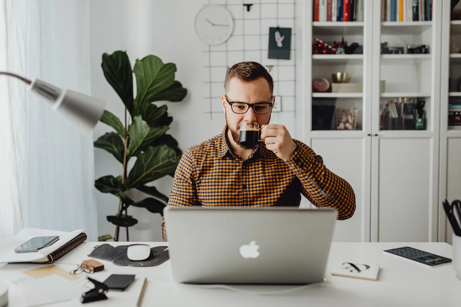 Person using a laptop with a CRM dashboard in an office