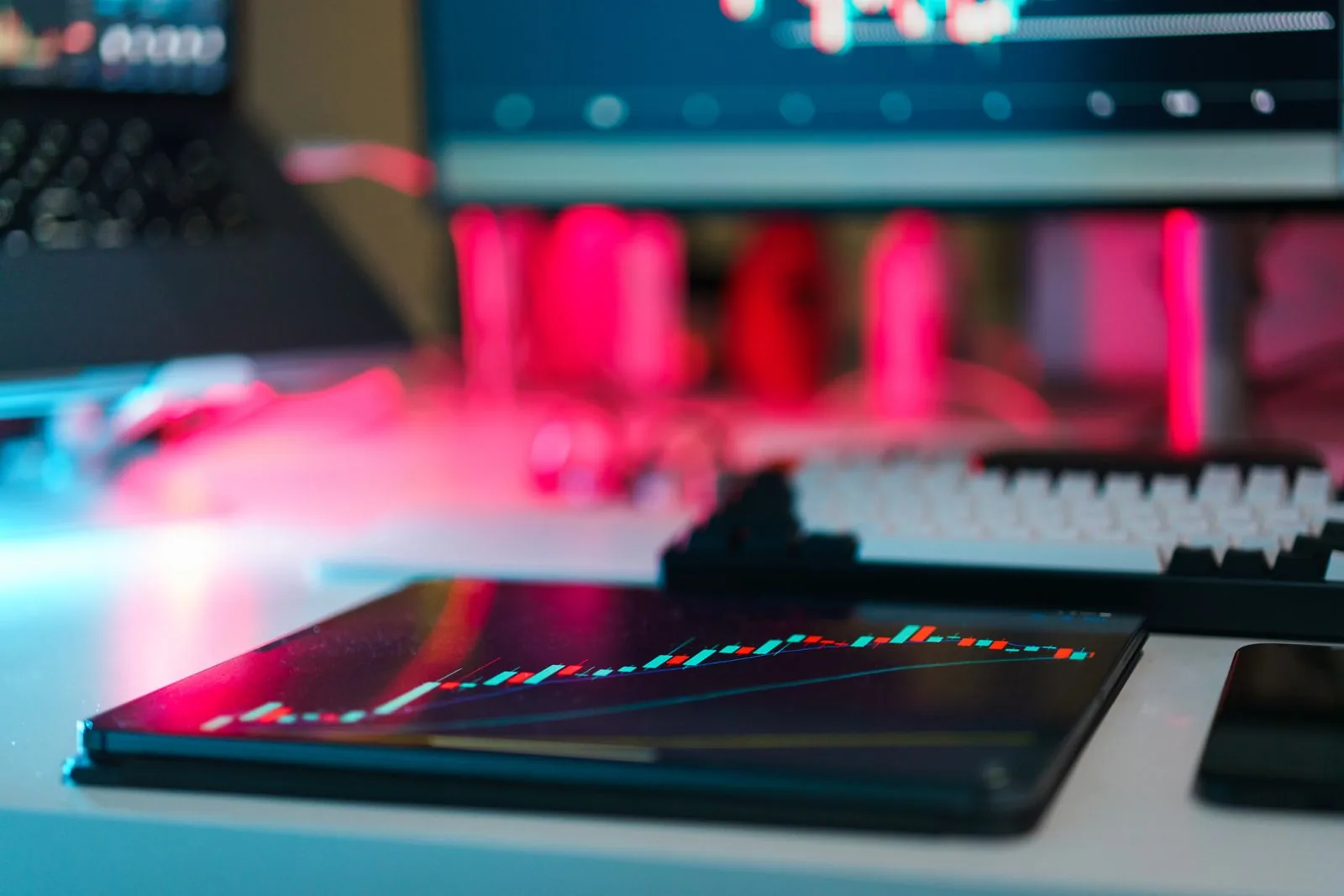 Wall of financial trading screens in a dark office