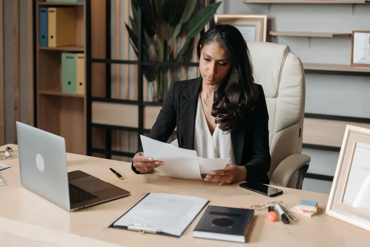 Compliance officer reviewing documents in an office