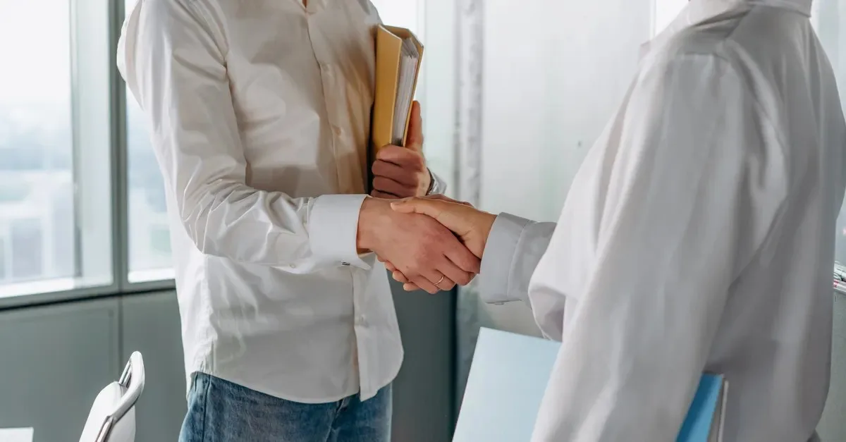 Business partners shaking hands closing a deal