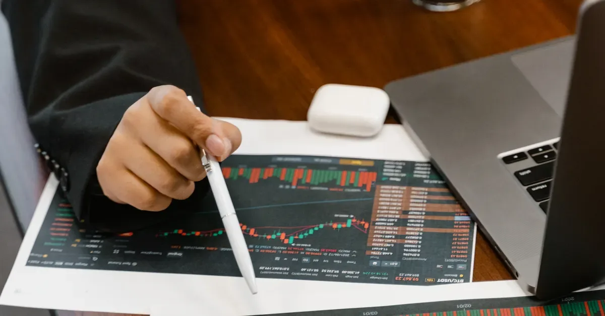 Risk analyst studying financial charts on a screen