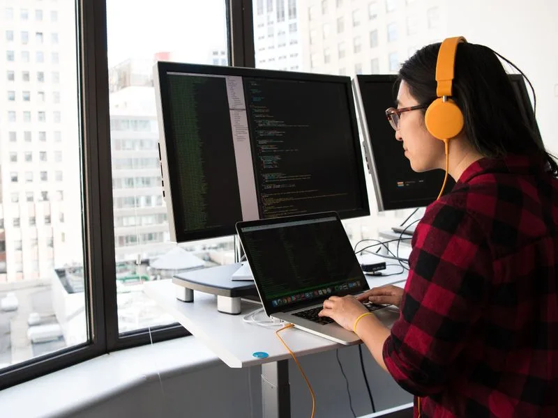 Software developers pair programming in an office